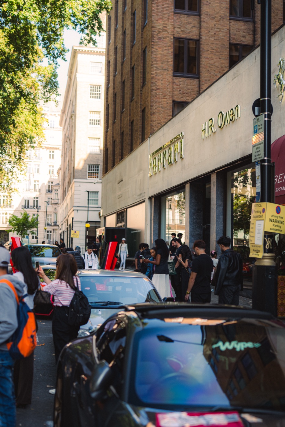 Crowd outside the H.R. Owen Ferrari showroom with a wype-branded car