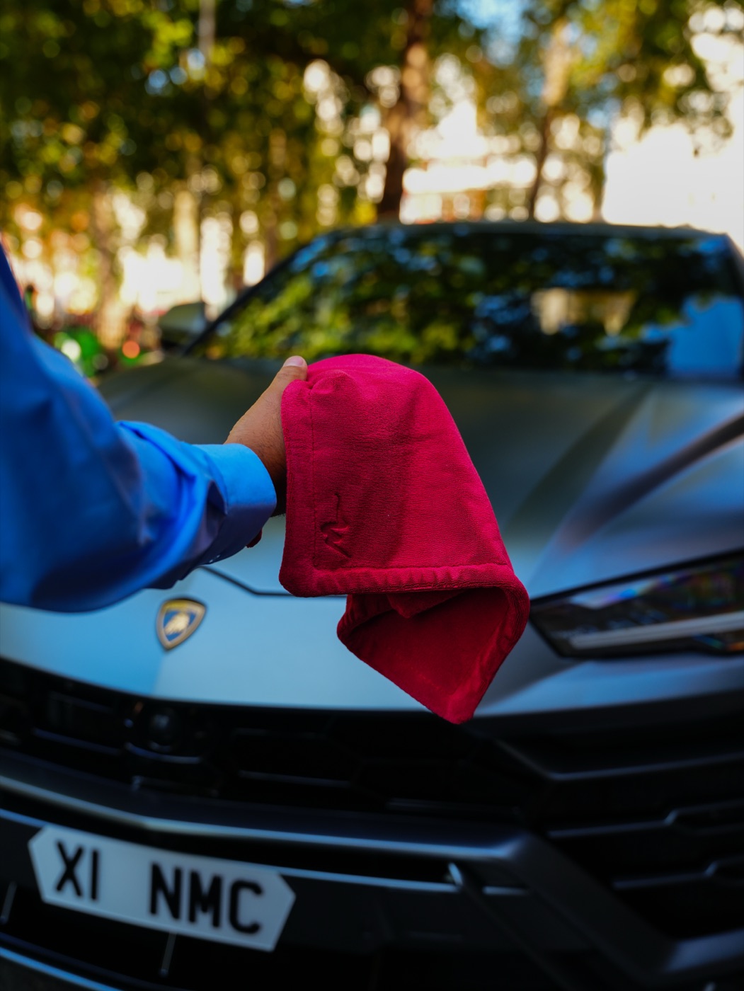 MicroWype+ held in front of a Lamborghini Urus