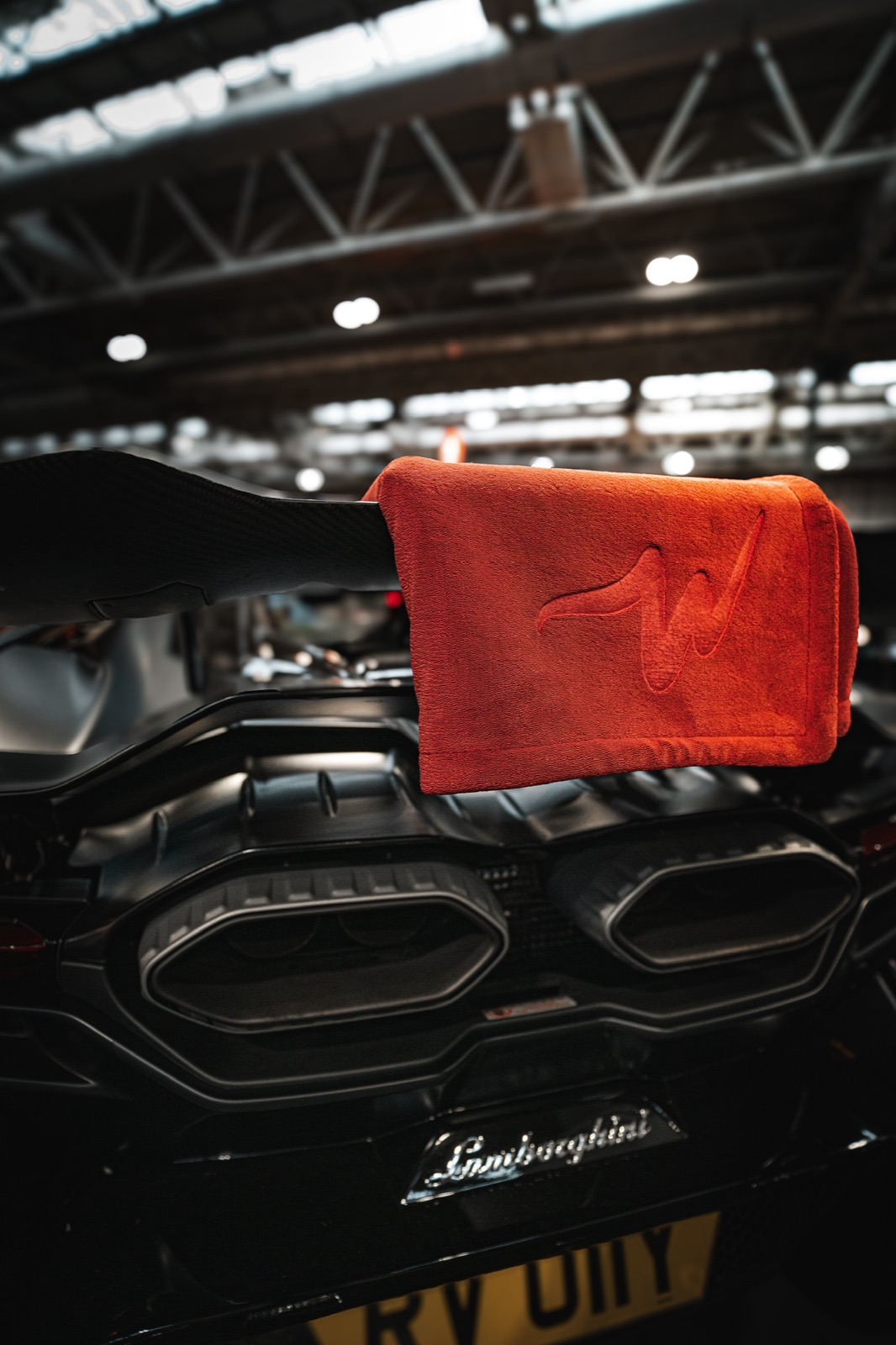 NanoWype+ towel draped over a Lamborghini carbon rear wing