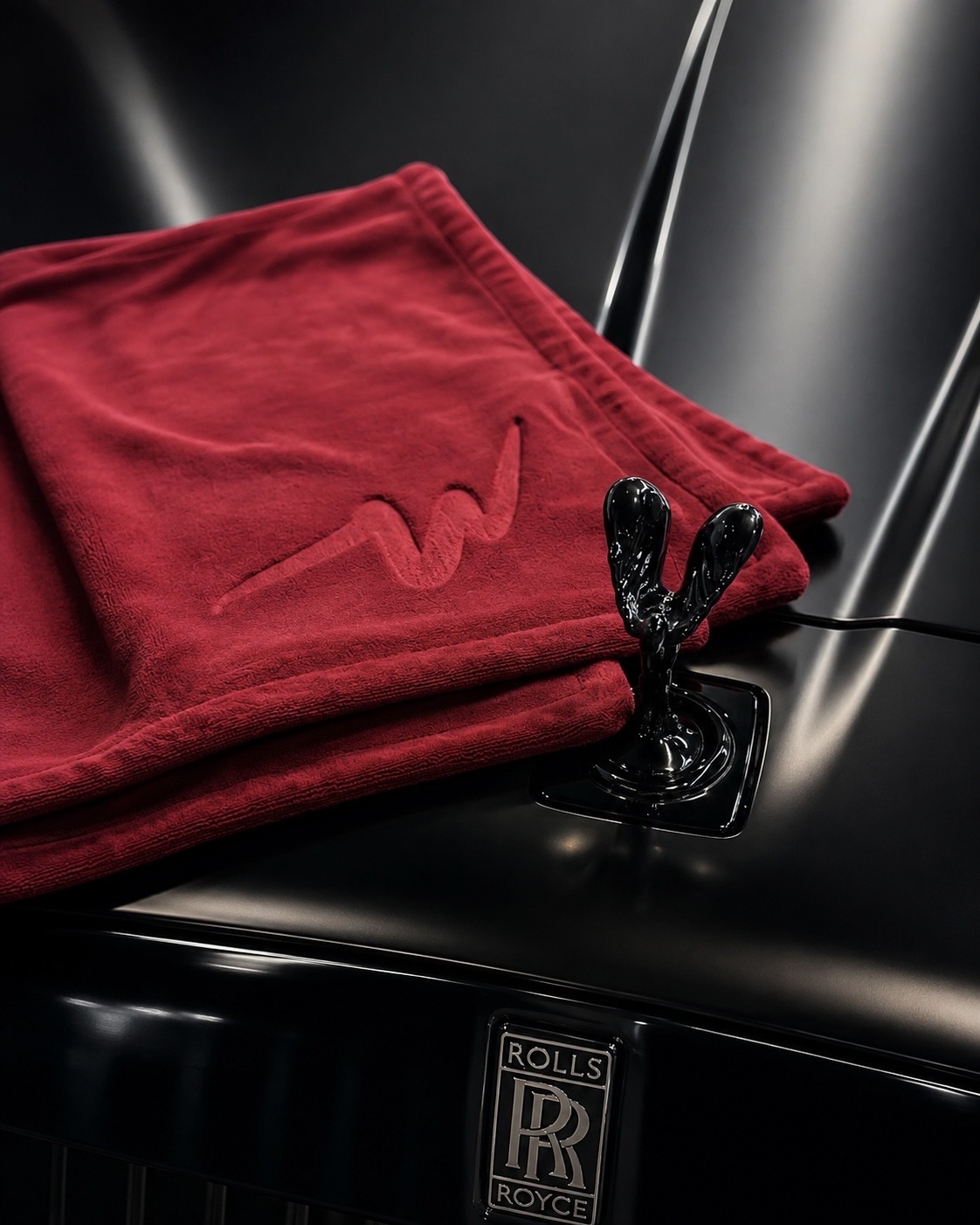 NanoWype+ towel folded on a Rolls-Royce bonnet beside the Spirit of Ecstasy