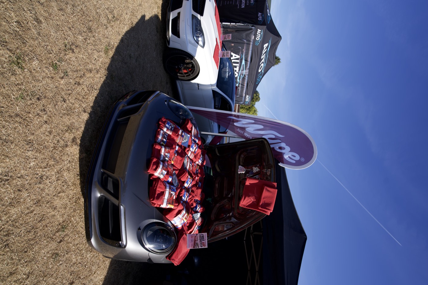 wype flag and red towels laid out in the boot of a Porsche at a PistonHeads meet